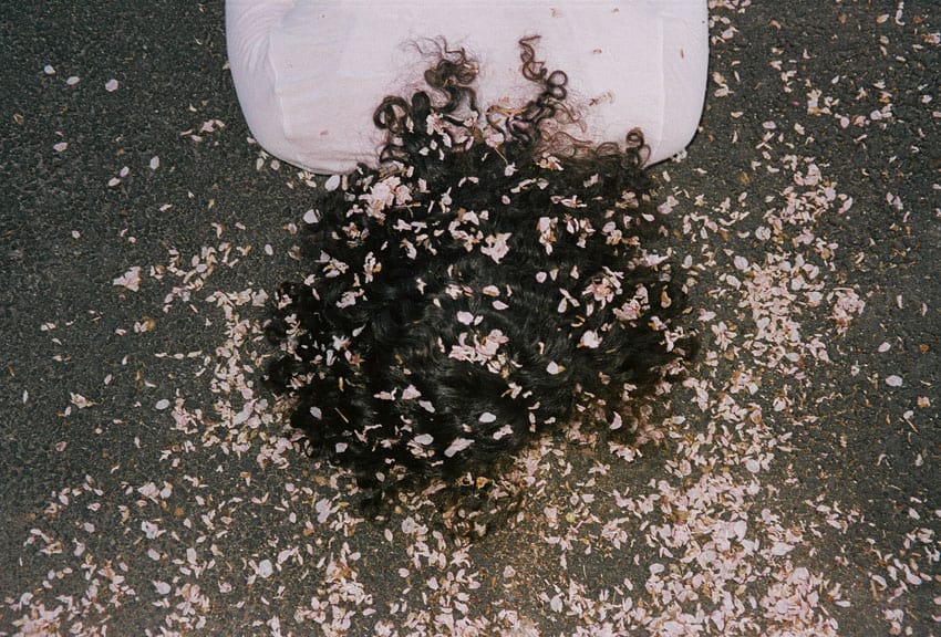 Woman face down on the ground with flowers in her hair - The Seed I Nurtured Fine Art Series by Chloe Xiang on Shoot It With Film