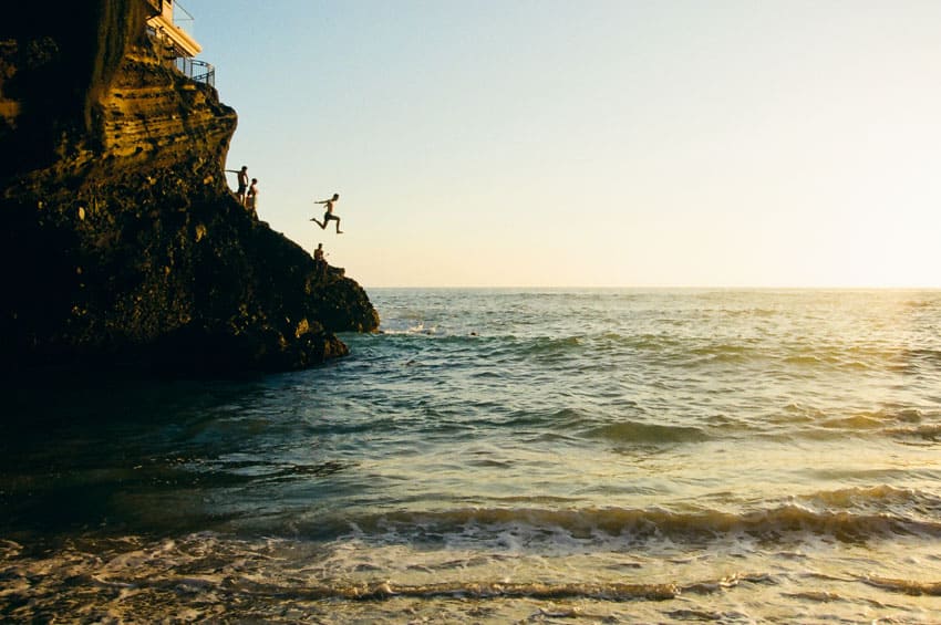 Film image of a person jumping off a cliff into the water - Utilizing Perspective in Film Photography by David Rose on Shoot It With Film