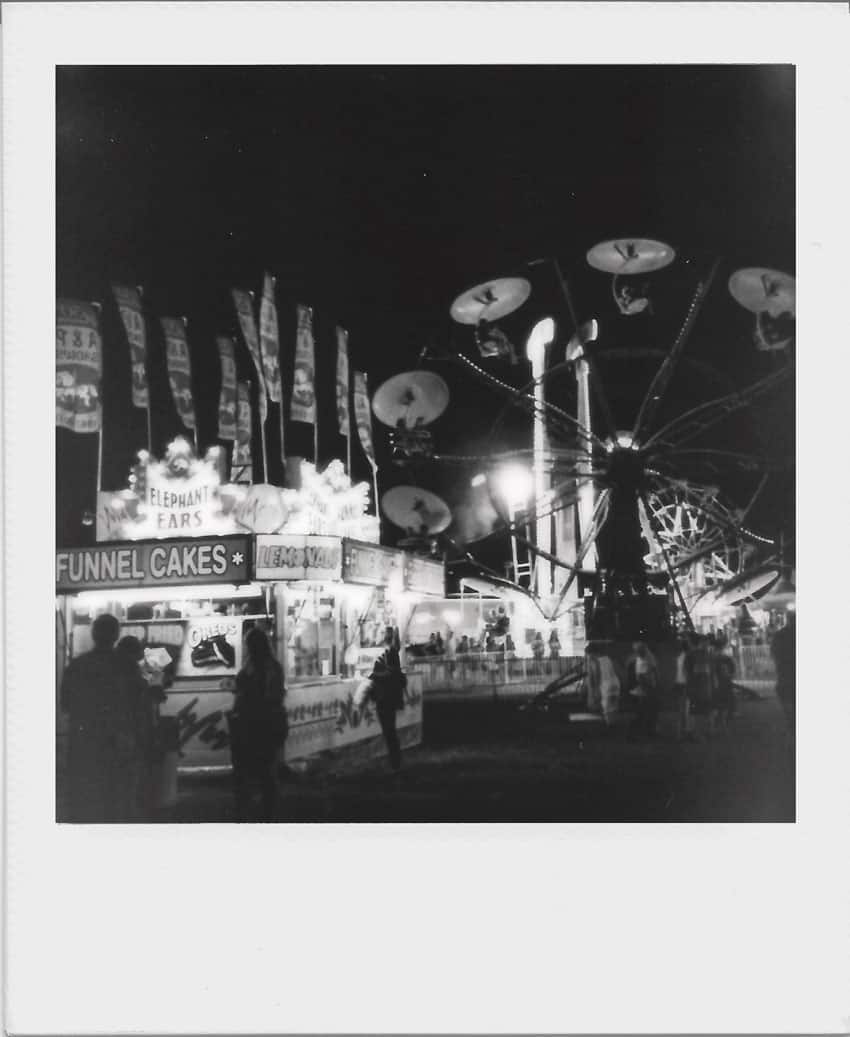 B&W Polaroid image of a carnival - Polaroid and Instax Film Comparison by Samantha Stortecky on Shoot It With Film