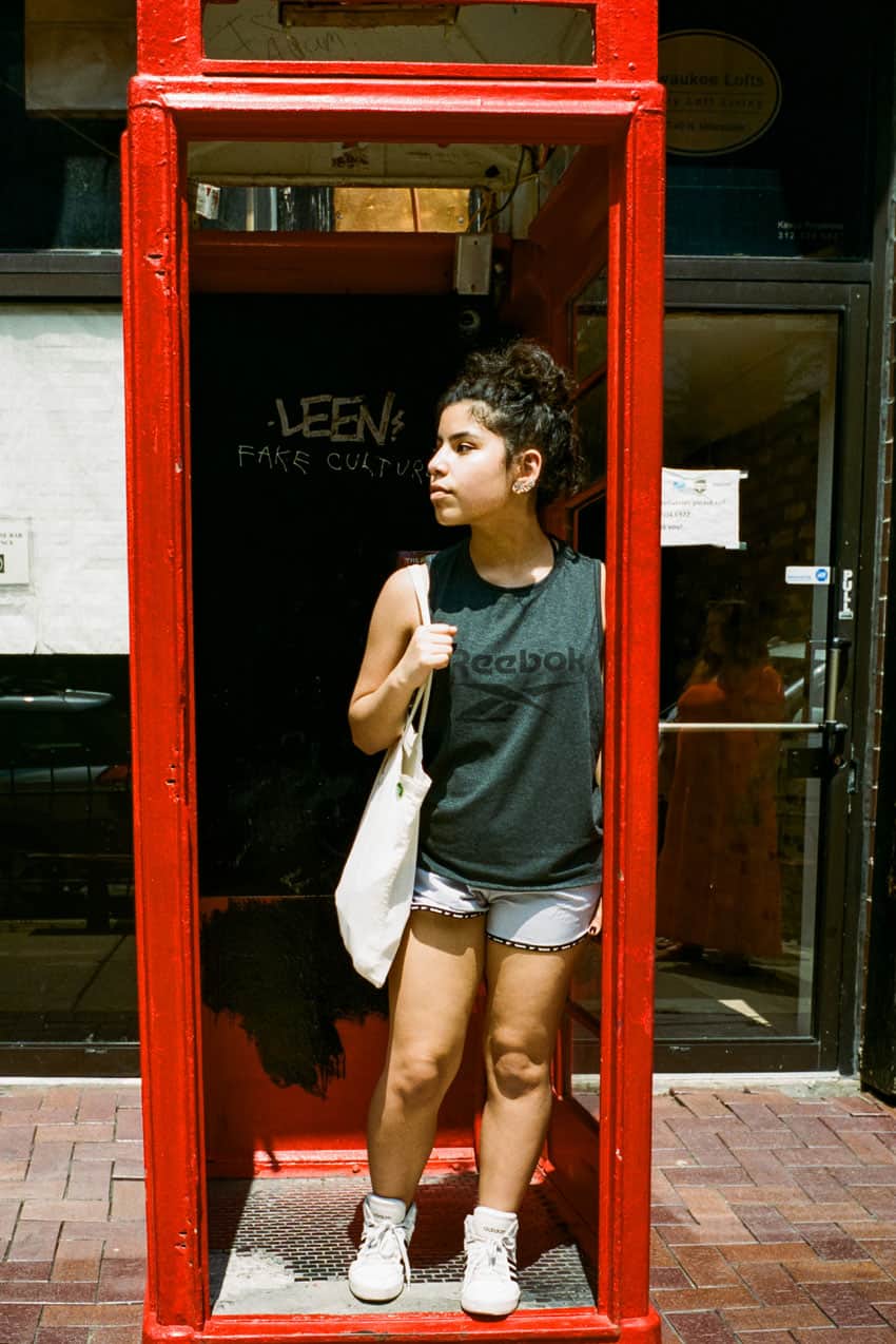 35mm film image of a woman in a phone booth - Contax G2 Film Camera Review on Shoot It With Film