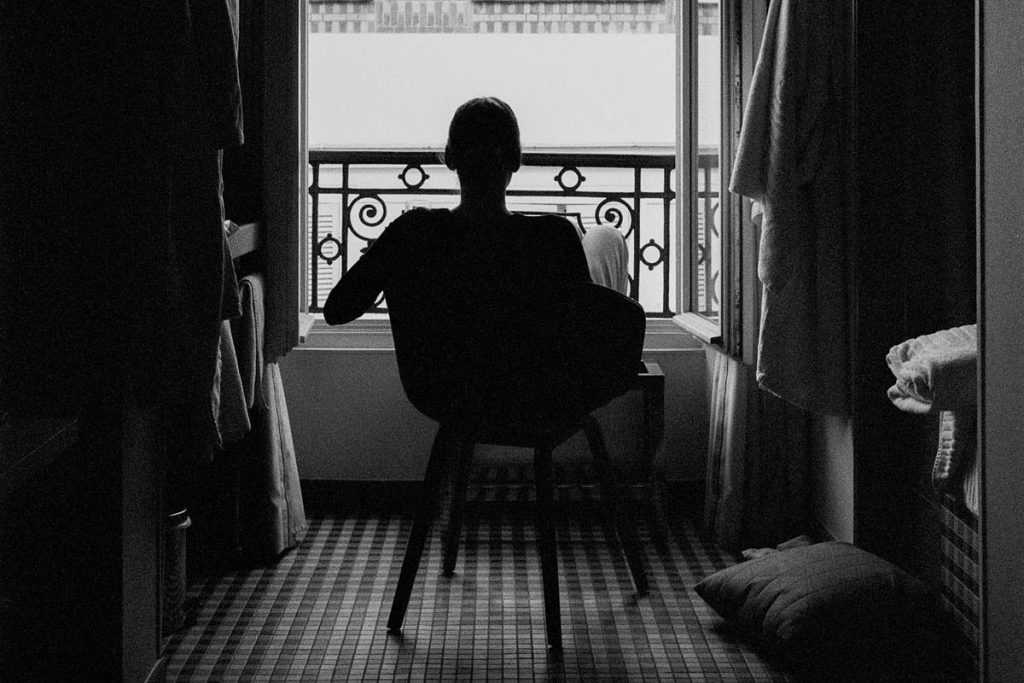 Film image of a woman looking out a window - Tips for Recapturing Your Creativity by Drew Evans on Shoot It With Film